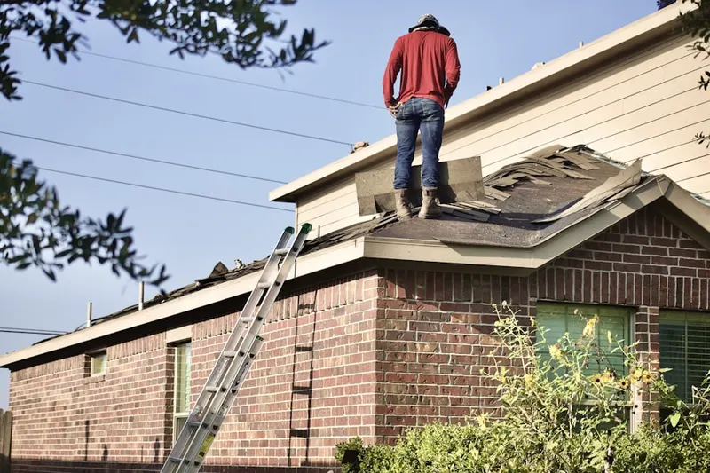 Professional roofer working on a residential roof in Mill Ridge North